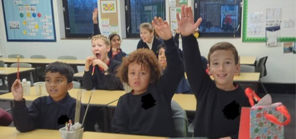 Eager children raising hands in French class